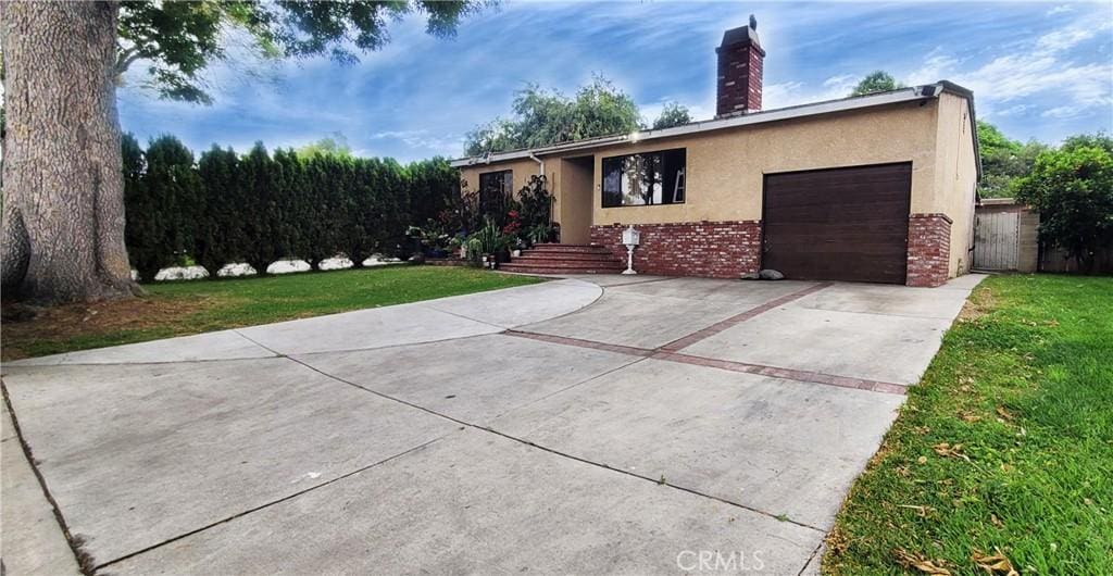 13129 Helmer Dr, Whittier, CA 90602 - ranch-style house featuring an attached garage, stucco siding, driveway, a chimney, and a front lawn