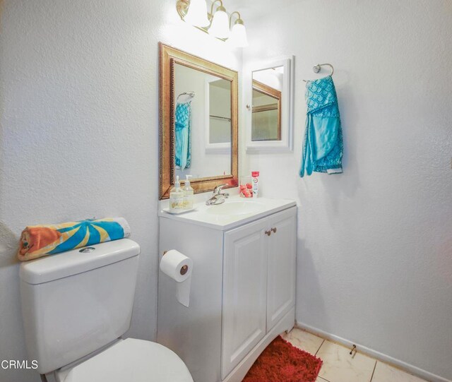 4578 Saviers Rd, Oxnard, CA 93033 - bathroom with toilet, vanity, tile patterned floors, and baseboards