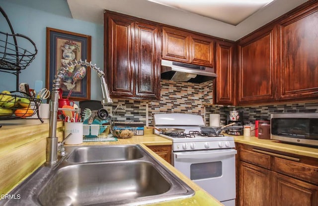 4578 Saviers Rd, Oxnard, CA 93033 - kitchen with white gas range oven, under cabinet range hood, light countertops, and stainless steel microwave