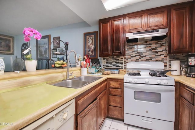 4578 Saviers Rd, Oxnard, CA 93033 - kitchen with white appliances, under cabinet range hood, a sink, light countertops, and decorative backsplash