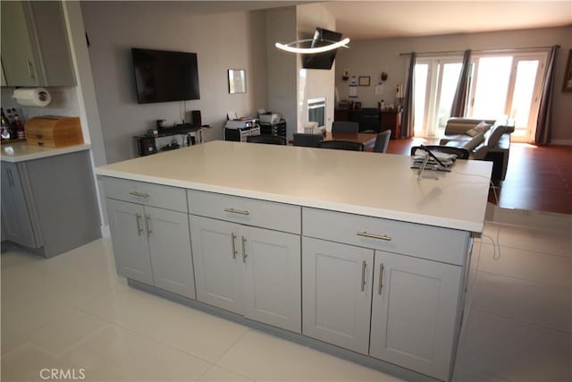 220 S Guadalupe Ave Unit 5, Redondo Beach, CA 90277 - kitchen with gray cabinets, light countertops, light tile patterned floors, and a center island