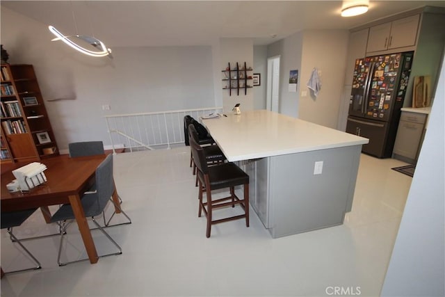 220 S Guadalupe Ave Unit 5, Redondo Beach, CA 90277 - kitchen featuring black fridge with ice dispenser, gray cabinets, a kitchen breakfast bar, light countertops, and a desk