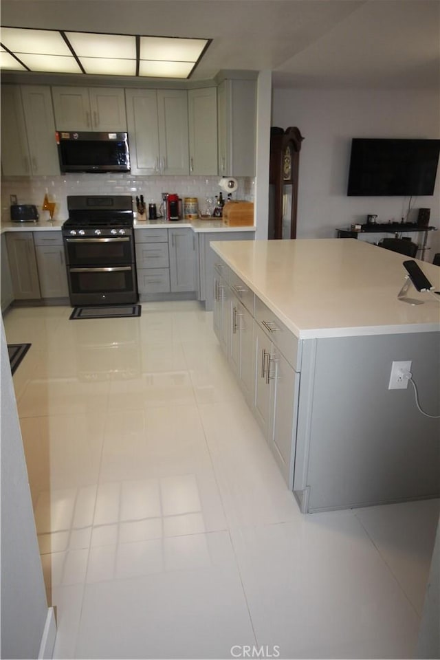 220 S Guadalupe Ave Unit 5, Redondo Beach, CA 90277 - kitchen with range with two ovens, gray cabinets, decorative backsplash, light countertops, and light tile patterned flooring