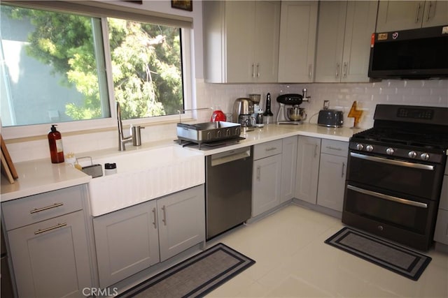 220 S Guadalupe Ave Unit 5, Redondo Beach, CA 90277 - kitchen with range with two ovens, stainless steel dishwasher, gray cabinetry, and backsplash