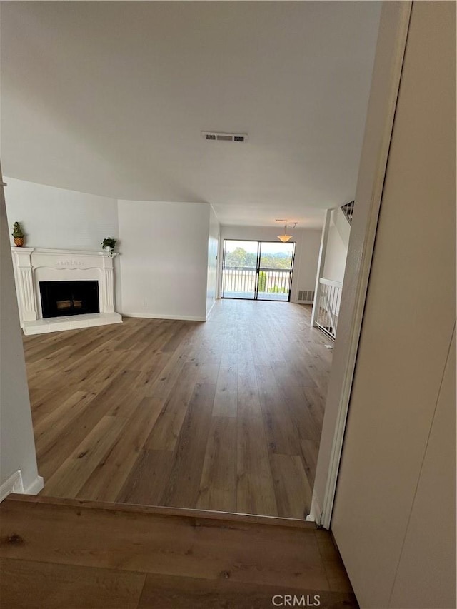 6990 Caminito Perico, San Diego, CA 92119 - unfurnished living room with hardwood / wood-style flooring and a fireplace with raised hearth