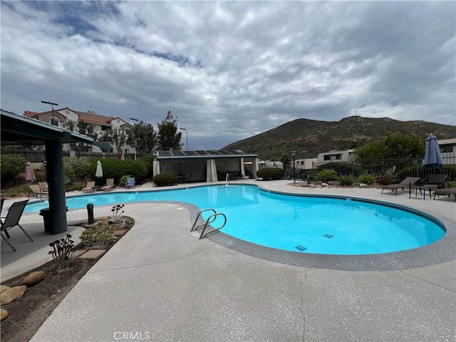 6990 Caminito Perico, San Diego, CA 92119 - community pool with a mountain view and a patio area