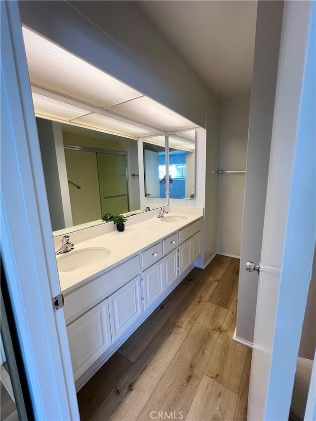 6990 Caminito Perico, San Diego, CA 92119 - bathroom featuring wood finished floors and double vanity