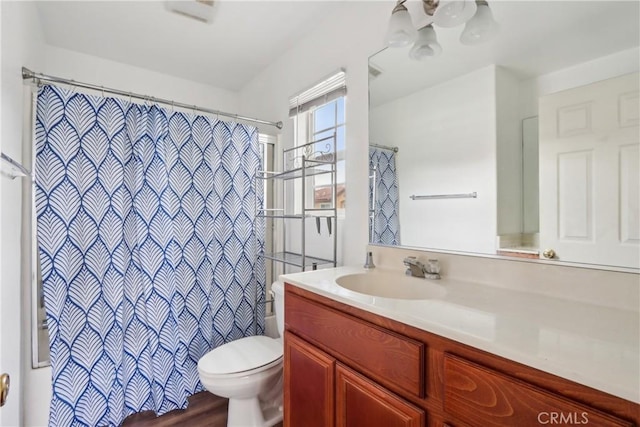 full bath with toilet, vanity, and a shower with shower curtain