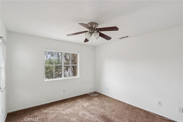 unfurnished room with a ceiling fan, carpet floors, and baseboards
