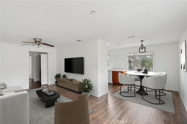 living room featuring light wood-style flooring and ceiling fan