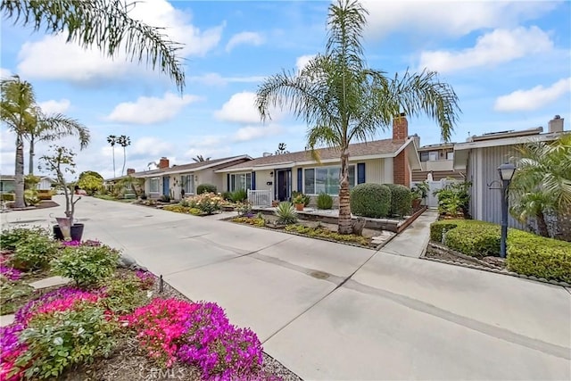 249 Monte Vis Unit 8, San Clemente, CA 92672 - ranch-style home featuring fence, a residential view, and a chimney