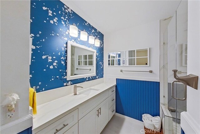 full bath with a stall shower and vanity