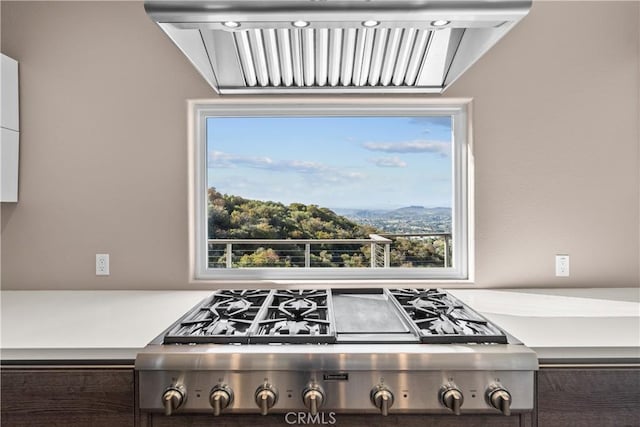 561 S Ventu Park Rd, Newbury Park, CA 91320 - kitchen view of stainless steel gas stovetop, exhaust hood, and light countertops