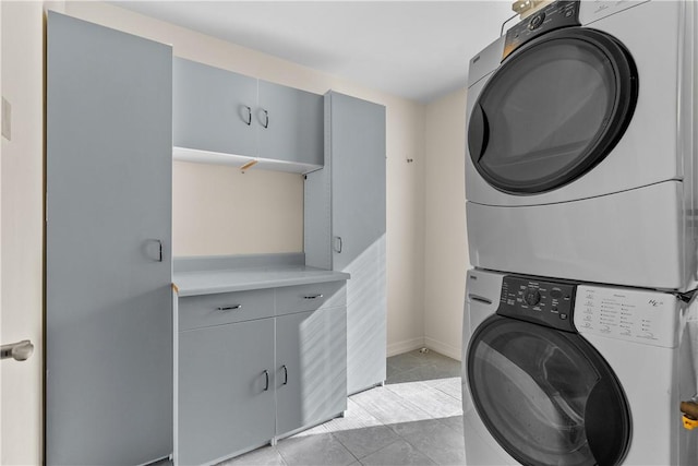 561 S Ventu Park Rd, Newbury Park, CA 91320 - laundry area with stacked washer / drying machine, light tile patterned floors, and cabinet space