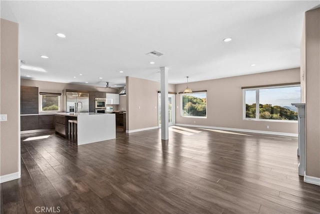 561 S Ventu Park Rd, Newbury Park, CA 91320 - unfurnished living room featuring dark wood-type flooring, ceiling fan, decorative columns, and recessed lighting