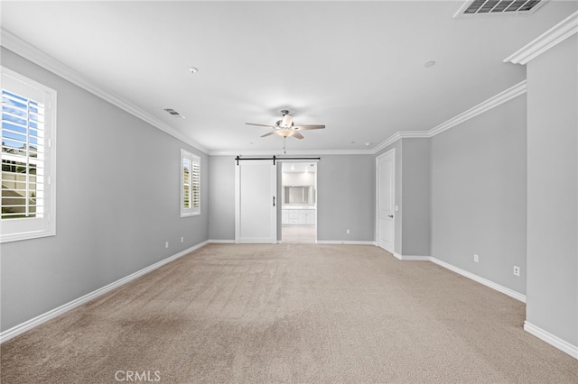 33378 Barmetta Ln, Temecula, CA 92592 - unfurnished room featuring a barn door, light colored carpet, a ceiling fan, baseboards, and crown molding