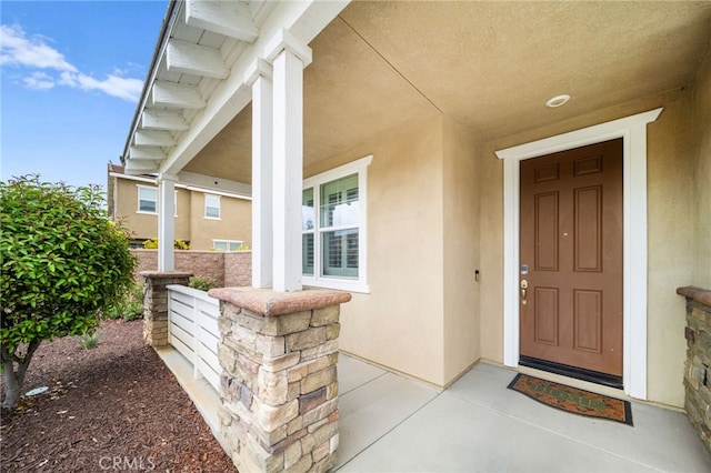 33378 Barmetta Ln, Temecula, CA 92592 - view of exterior entry with stucco siding and a porch