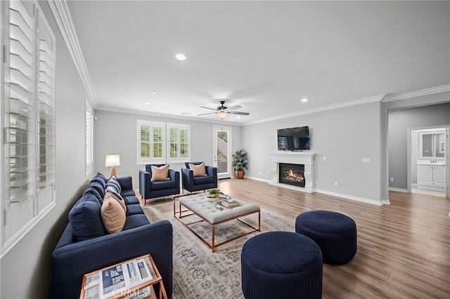 33378 Barmetta Ln, Temecula, CA 92592 - living room with recessed lighting, crown molding, wood finished floors, baseboards, and a glass covered fireplace