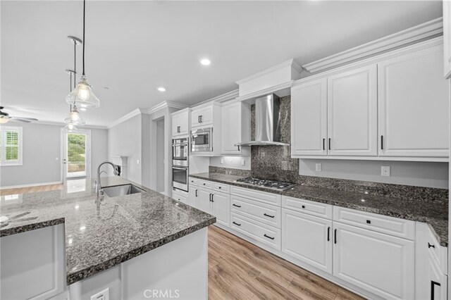 33378 Barmetta Ln, Temecula, CA 92592 - kitchen with wall chimney range hood, a sink, appliances with stainless steel finishes, white cabinets, and pendant lighting