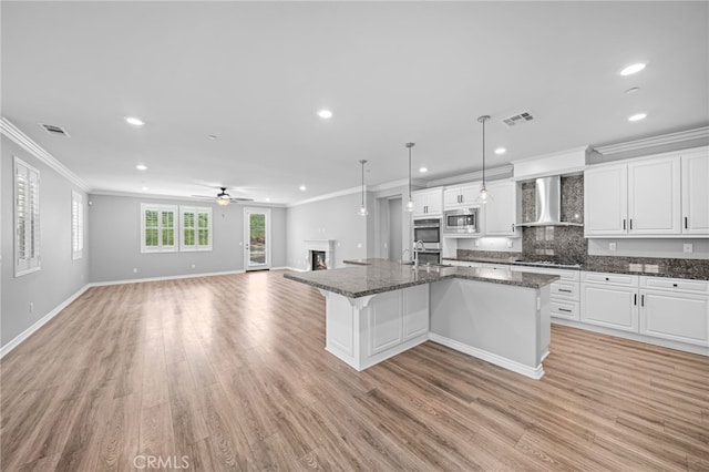 33378 Barmetta Ln, Temecula, CA 92592 - kitchen featuring wall chimney exhaust hood, stainless steel appliances, crown molding, open floor plan, and recessed lighting