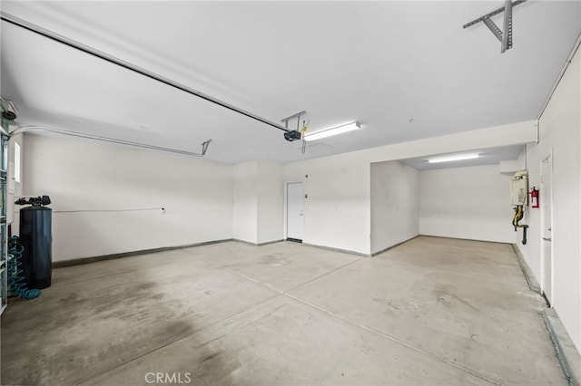 33378 Barmetta Ln, Temecula, CA 92592 - garage with a garage door opener and baseboards
