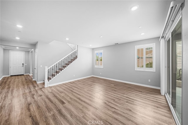 33378 Barmetta Ln, Temecula, CA 92592 - unfurnished living room with stairway, baseboards, recessed lighting, and wood finished floors