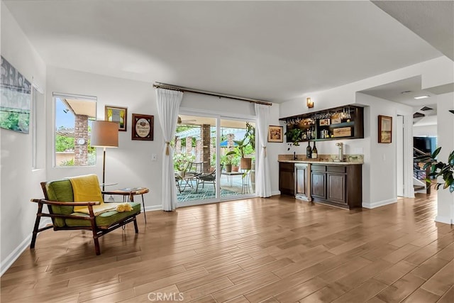 1475 Trenton Dr, Riverside, CA 92506 - sitting room featuring wet bar, light wood-style floors, and baseboards