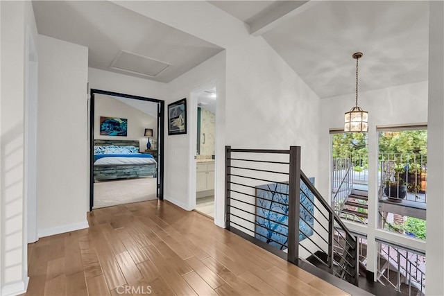 1475 Trenton Dr, Riverside, CA 92506 - hall featuring an upstairs landing, wood finished floors, attic access, baseboards, and a chandelier