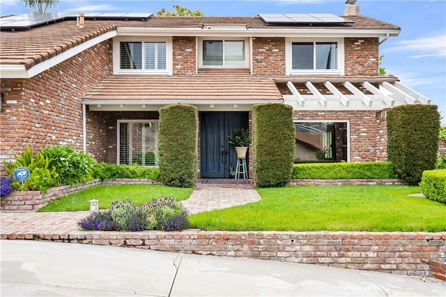 1475 Trenton Dr, Riverside, CA 92506 - view of front of property with a front lawn, roof mounted solar panels, and brick siding
