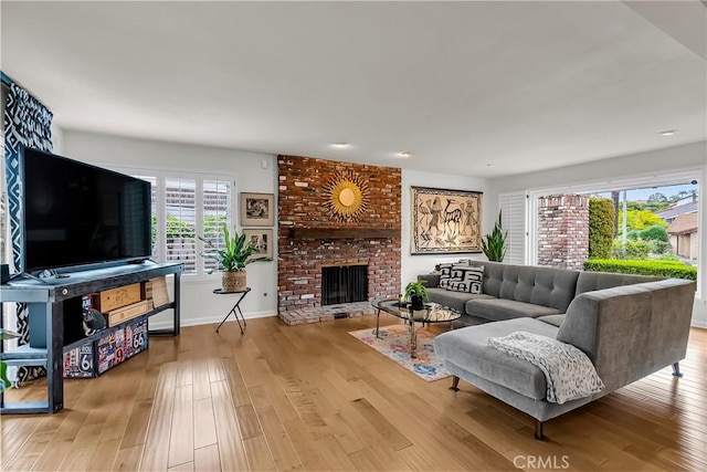 1475 Trenton Dr, Riverside, CA 92506 - living room with wood finished floors, a brick fireplace, and baseboards