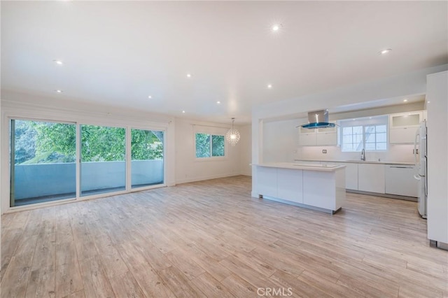 8963 Burton Way Unit 103, Los Angeles, CA 90048 - unfurnished living room featuring light wood-style flooring, a sink, recessed lighting, and baseboards