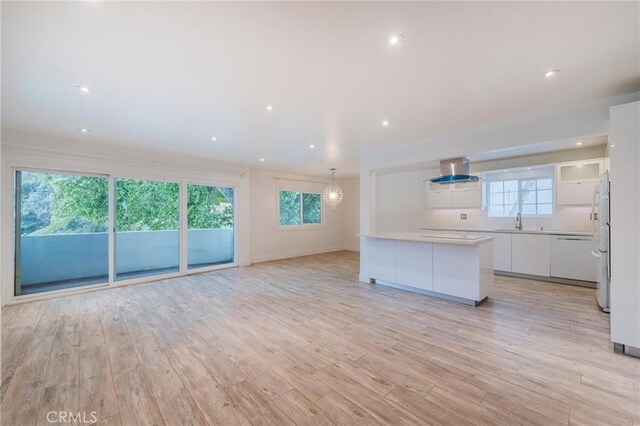 8963 Burton Way Unit 103, Los Angeles, CA 90048 - unfurnished living room featuring light wood finished floors, a sink, recessed lighting, and baseboards