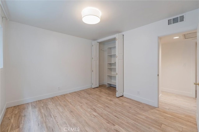 unfurnished bedroom with light wood-style floors, baseboards, and a closet