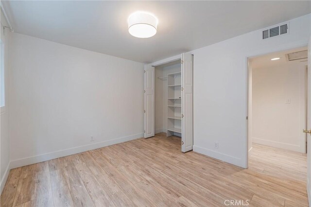 8963 Burton Way Unit 103, Los Angeles, CA 90048 - unfurnished bedroom with light wood-style flooring, baseboards, and a closet