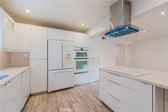 8963 Burton Way Unit 103, Los Angeles, CA 90048 - kitchen with white appliances, island exhaust hood, white cabinetry, modern cabinets, and recessed lighting