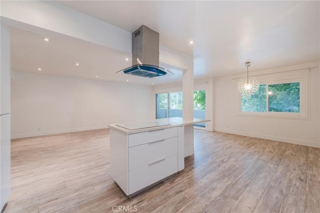 kitchen with island exhaust hood, modern cabinets, white cabinets, light wood-style floors, and recessed lighting
