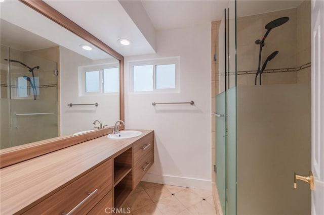 full bathroom featuring a stall shower, baseboards, tile patterned flooring, vanity, and recessed lighting