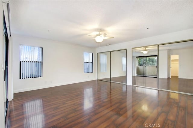 43195 Andrade Ave Unit A, Hemet, CA 92544 - unfurnished bedroom featuring wood finished floors, two closets, baseboards, and ceiling fan