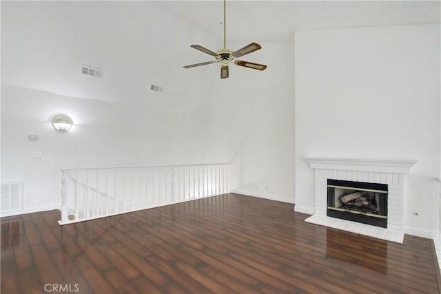 43195 Andrade Ave Unit A, Hemet, CA 92544 - unfurnished living room featuring wood finished floors, a ceiling fan, baseboards, and a brick fireplace