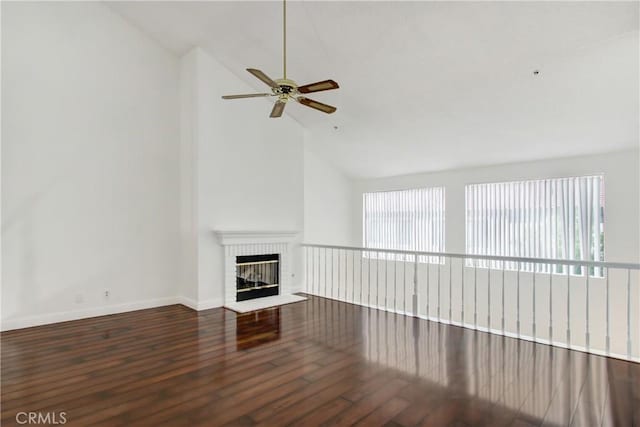 43195 Andrade Ave Unit A, Hemet, CA 92544 - unfurnished living room featuring a brick fireplace, wood finished floors, a ceiling fan, baseboards, and high vaulted ceiling