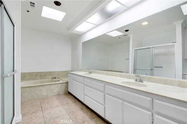 43195 Andrade Ave Unit A, Hemet, CA 92544 - full bath with a skylight, double vanity, a garden tub, a stall shower, and tile patterned floors
