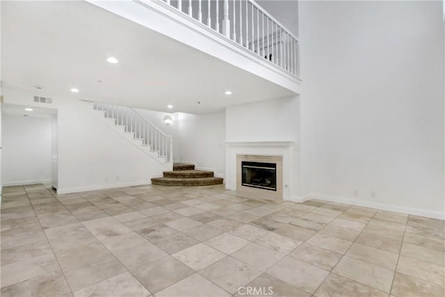 43195 Andrade Ave Unit A, Hemet, CA 92544 - unfurnished living room with stairway, recessed lighting, light tile patterned floors, a fireplace, and baseboards