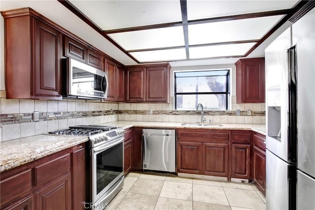 43195 Andrade Ave Unit A, Hemet, CA 92544 - kitchen with appliances with stainless steel finishes, a sink, backsplash, and light stone counters