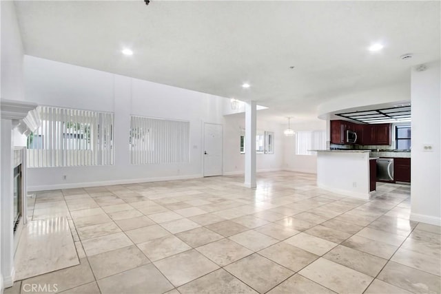 43195 Andrade Ave Unit A, Hemet, CA 92544 - unfurnished living room featuring light tile patterned flooring, recessed lighting, a fireplace, and baseboards