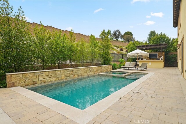 view of swimming pool with area for grilling, a patio, an in-ground hot tub, and a fenced backyard