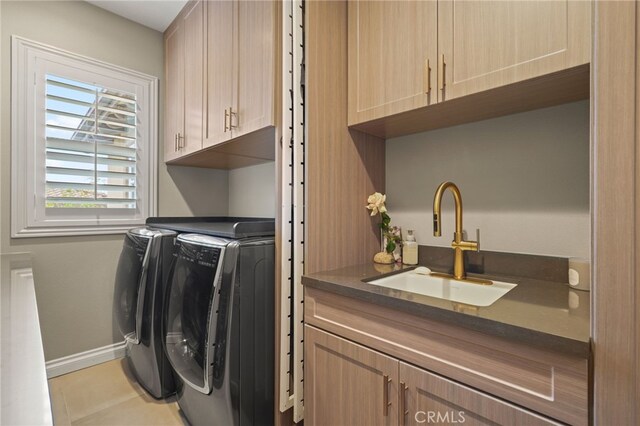 laundry area featuring cabinet space, washing machine and clothes dryer, and baseboards