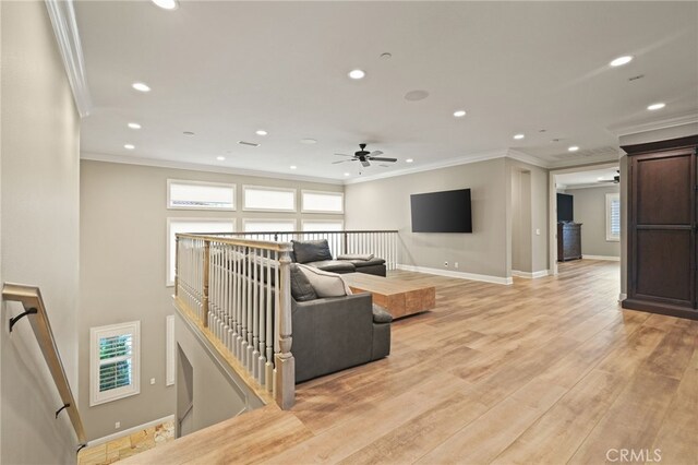 living area featuring crown molding, recessed lighting, a ceiling fan, light wood-style floors, and baseboards