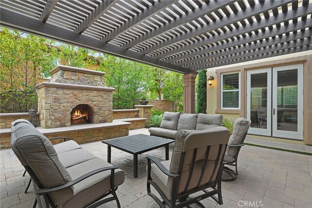view of patio / terrace with french doors, an outdoor living space with a fireplace, and a pergola