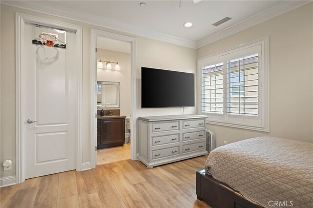 bedroom with light wood finished floors, crown molding, recessed lighting, ensuite bathroom, and a sink