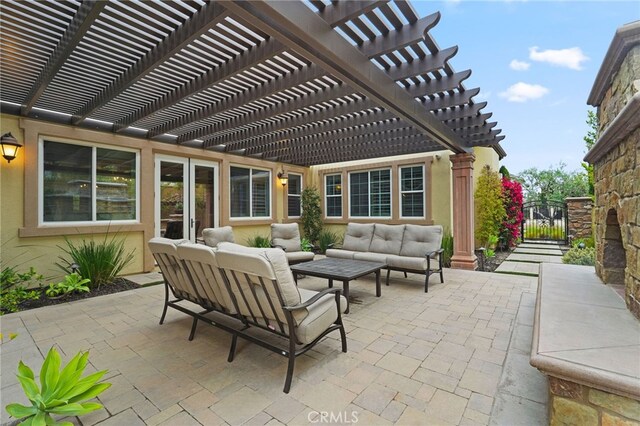 view of patio featuring an outdoor living space, a gate, and a pergola